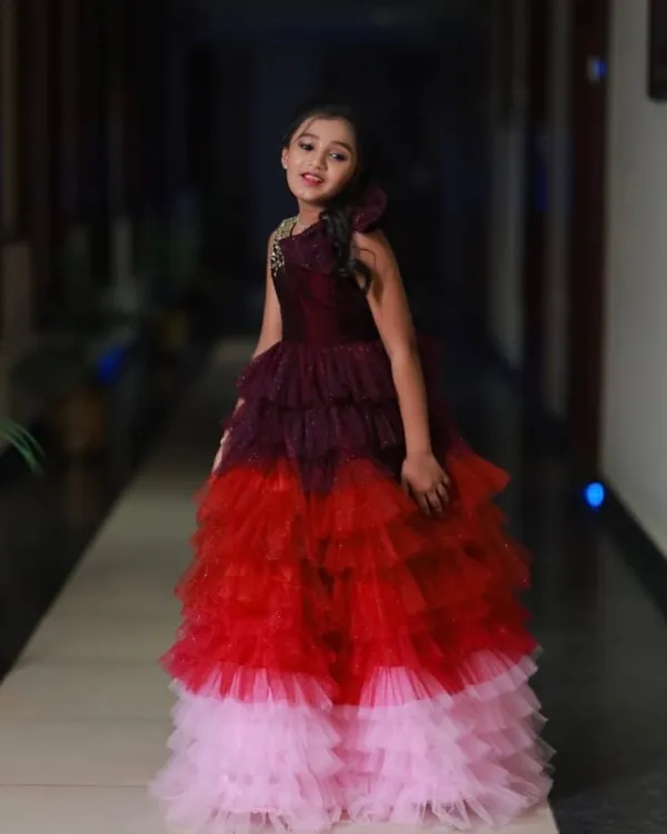 This is a beautiful color-layered gown I designed for a 10th birthday. It transitions from wine to red to pink, with sparkling details on the bodice.