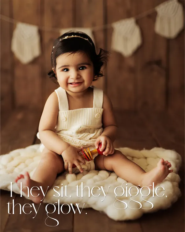 They sit, they giggle, they glow. This is the heart of a sitter session, capturing that perfect smile on a simple, rustic setup with a cozy wool blanket.