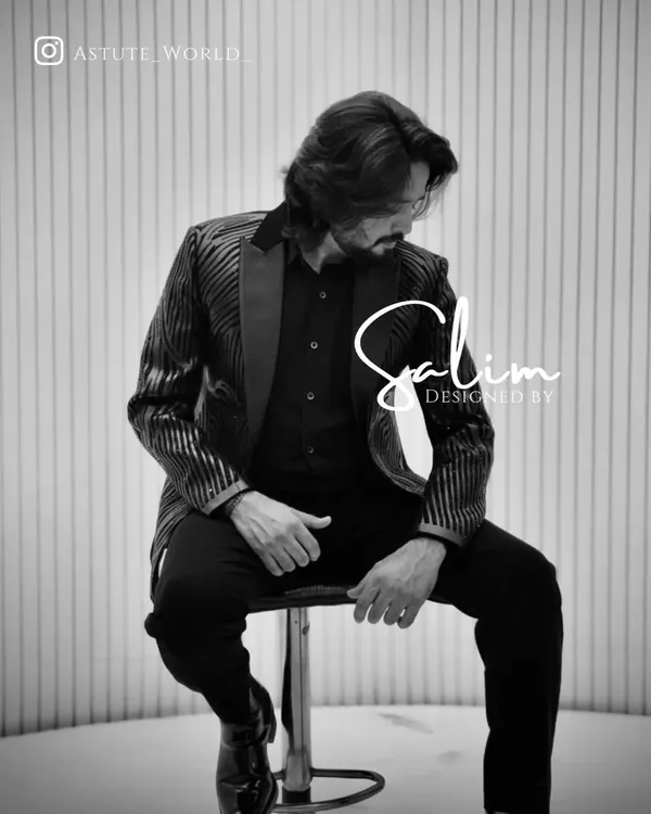 A black and white shot of a client in a striped blazer. This photo highlights the texture of the fabric and the sharp cut of the jacket.