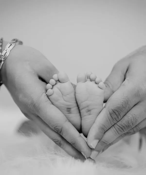 These tiny feet won't be tiny for long. We believe in capturing the small details and fleeting moments that tell the biggest stories of love. This is why we do what we do.