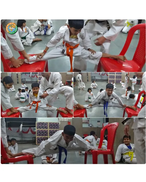Young students work diligently on their splits with the help of chairs. We use various tools to help students safely achieve their flexibility goals.
