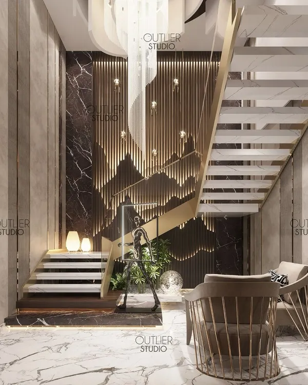 A sneak peek of the grand entrance lobby to our triplex masterpiece. A dramatic chandelier hangs above a sculptural staircase, with a feature wall of backlit wood panels creating a mountain-like silhouette.