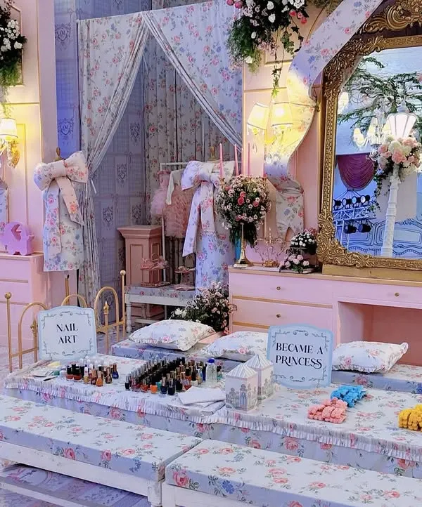 A "Become a Princess" pamper station, complete with personal vanities and a nail art bar. This interactive area was designed with floral fabrics and ornate mirrors to fit the royal theme.
