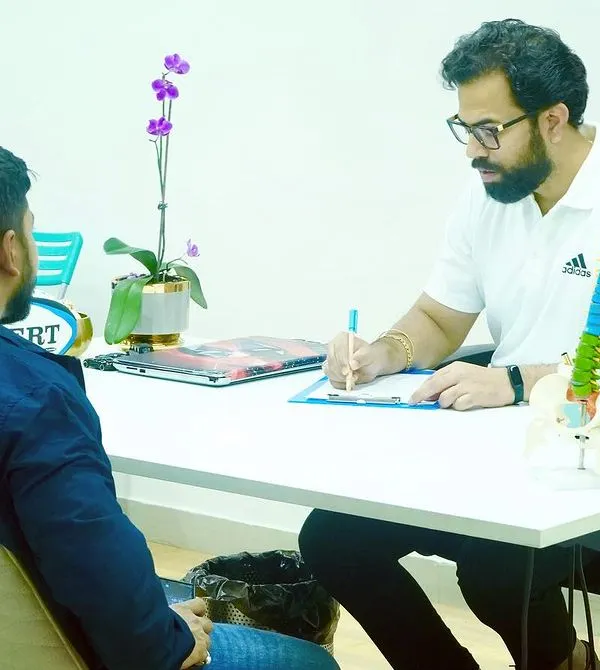 Every recovery journey starts with a detailed consultation. Here, I am taking the time to understand a client's history and symptoms to form an accurate diagnosis.