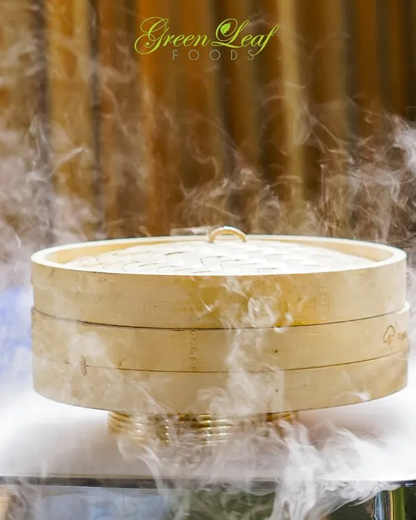 The drama of dry ice adds a touch of magic to this bamboo steamer. I use creative techniques like this to elevate the presentation of my dishes and create an unforgettable visual experience for your guests.