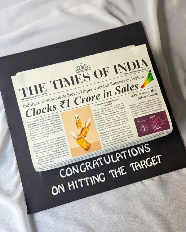 This edible newspaper cake celebrated a ₹1 Crore sales target for Indulgeo Essentials. It's a unique and memorable way to commemorate a huge team win, with every detail designed to look like a real front-page story.