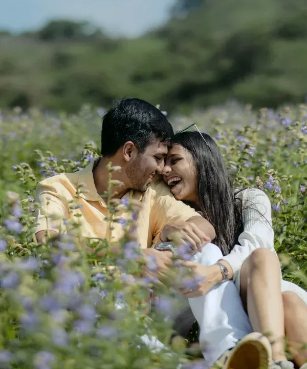 A moment of pure, uninhibited laughter in a field of purple flowers. This is the heart of my photography style: capturing real joy and connection in a beautiful, natural setting.