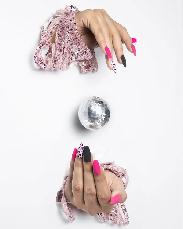 A professionally styled shot featuring matte fuchsia and black animal print nails. This stiletto shape set shows how I combine bold colors and trendy patterns for a high-fashion look.