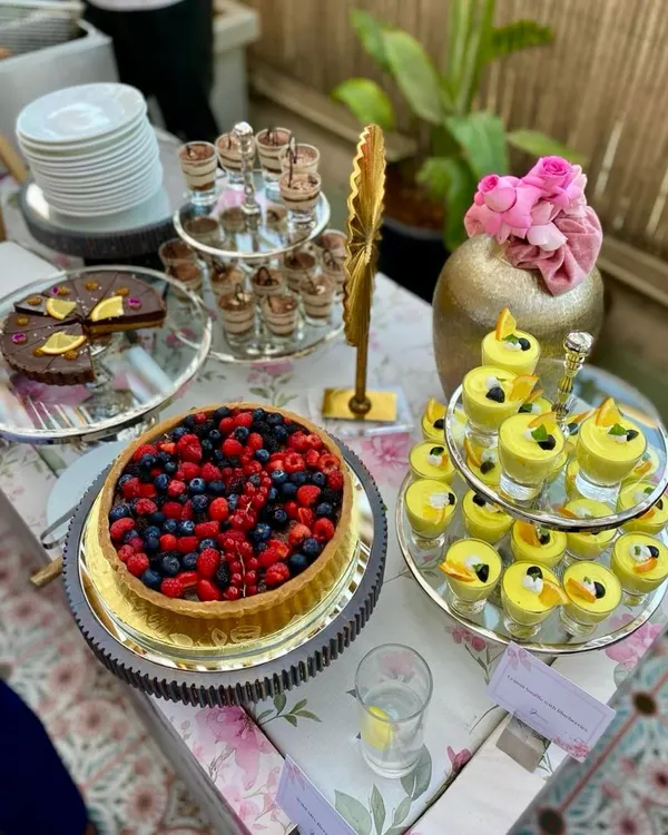 A dessert spread that promises pure indulgence. Featuring a fresh berry tart, individual tiramisu cups, and a zesty lemon soufflé, there's a sweet ending for every guest.