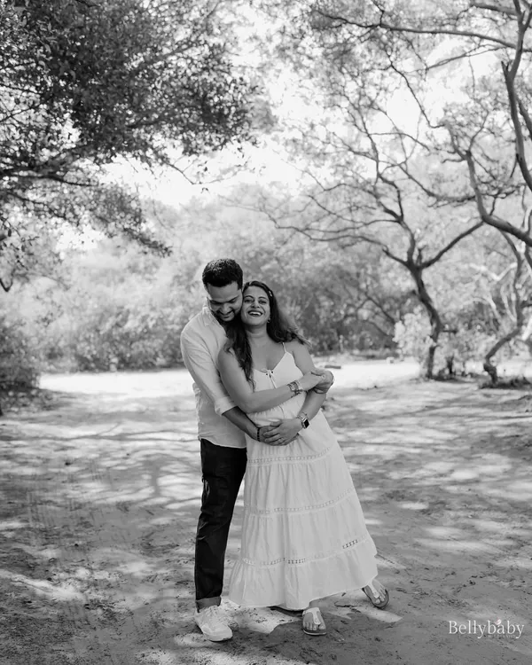 A moment of pure, unscripted laughter and joy between the parents-to-be. Black and white enhances the emotion, making this candid shot feel even more special.
