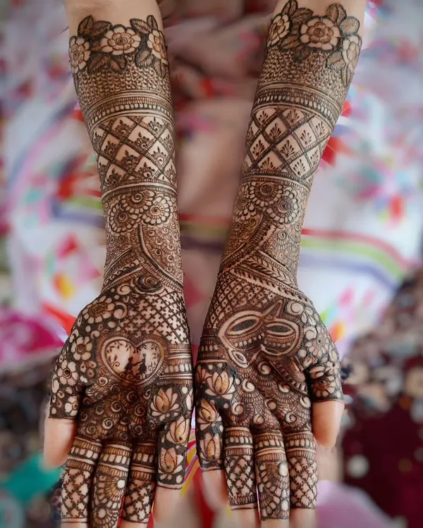 A complete bridal design that combines delicate floral work, traditional jaal patterns, and custom elements like the heart and kalash motifs. This is a perfect example of a full coverage design for the modern bride.