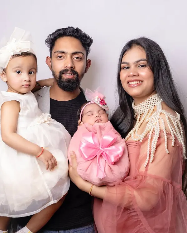 The first family portrait as a family of four. The older sister looks so proud, and the parents are filled with love for their two little ones. Capturing these moments with the whole family is so important.