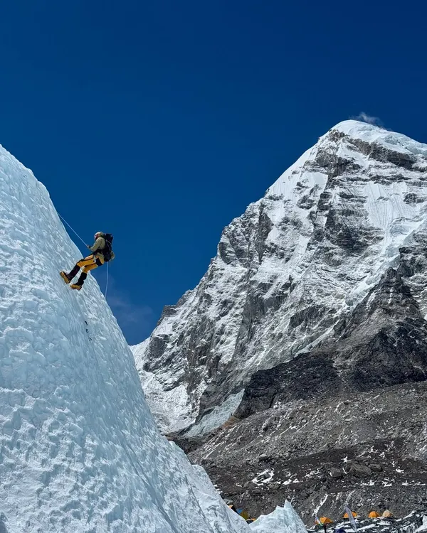This is what it feels like to be on the edge of the world. Here, a climber practices rappelling on a sheer ice wall near Everest Base Camp, with the magnificent peak of Pumori standing guard. It's in these moments of intense focus, surrounded by raw beauty, that you find out what you're truly made of.