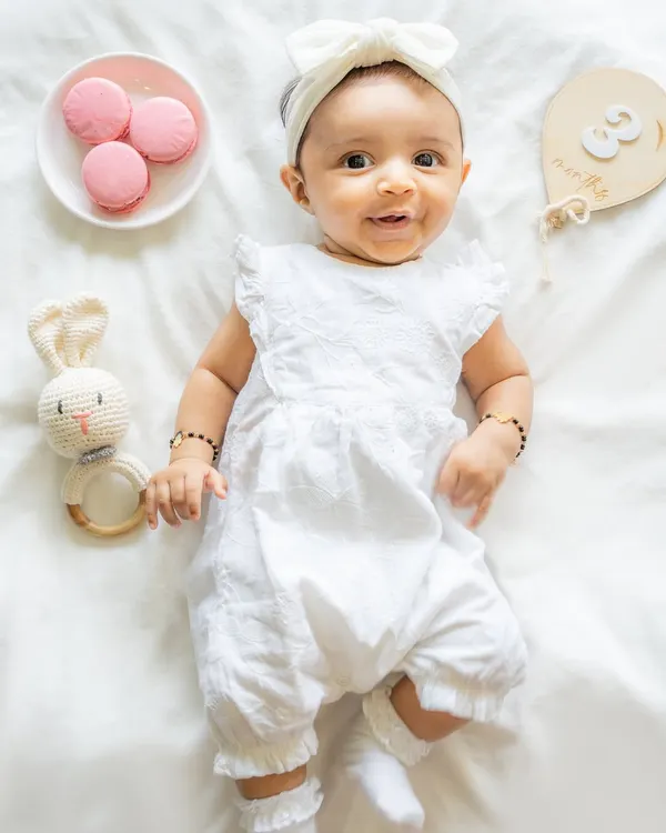 This is the kind of image that makes my heart sing. A simple, bright, and airy setup for a three-month milestone session. I focus on your baby's sweet expressions and tiny details, using natural light to create a timeless portrait you will cherish forever.