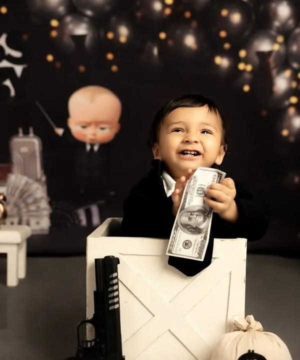 For his first birthday, we crowned him the 'Boss Baby'. This is one of my most popular creative themes, where I provide the full setup including the costume, props, and backdrop to capture your little one's big personality.