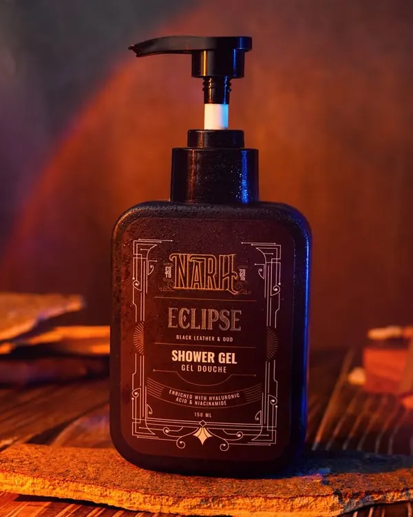 A moody, atmospheric shot of a shower gel bottle, using smoke and warm, dramatic lighting. This style of photography is excellent for creating a high-end, sophisticated brand identity.