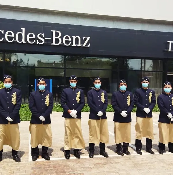 Our uniformed staff prepared to welcome guests at a corporate event for Mercedes-Benz. Our team's professionalism and attention to detail ensure a seamless experience that upholds the standards of luxury brands.