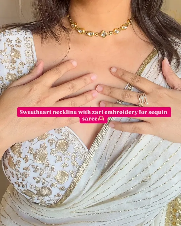 For a touch of glamour, a sweetheart neckline with zari embroidery is a timeless choice. It pairs beautifully with this sequin saree, creating a look that's perfect for a wedding or reception.