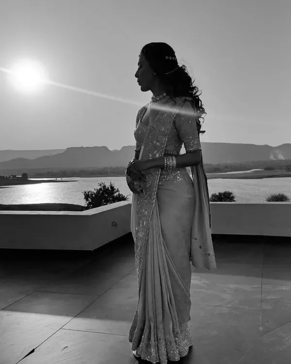 A beautiful silhouette of my client against the setting sun. The elegant drape of her saree creates a timeless and romantic memory of her engagement day.