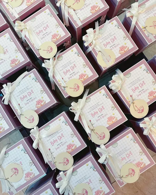 The sweetest way to share the sweetest news. These custom baby announcement favours feature adorable "Baby Girl" themed cards and tags, tied with white ribbons to our classic pink boxes.