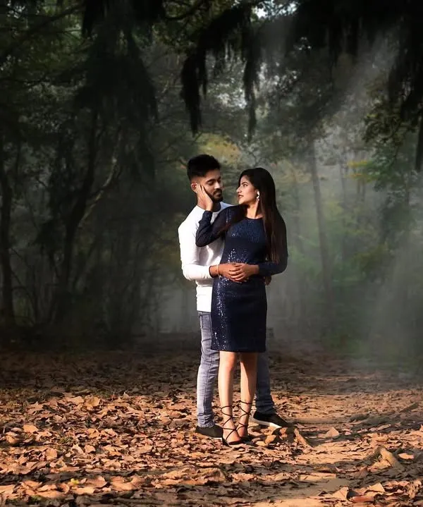 A romantic couple's portrait set in a misty, atmospheric forest. I use natural light and dramatic settings like this to create cinematic and memorable pre-wedding photographs.