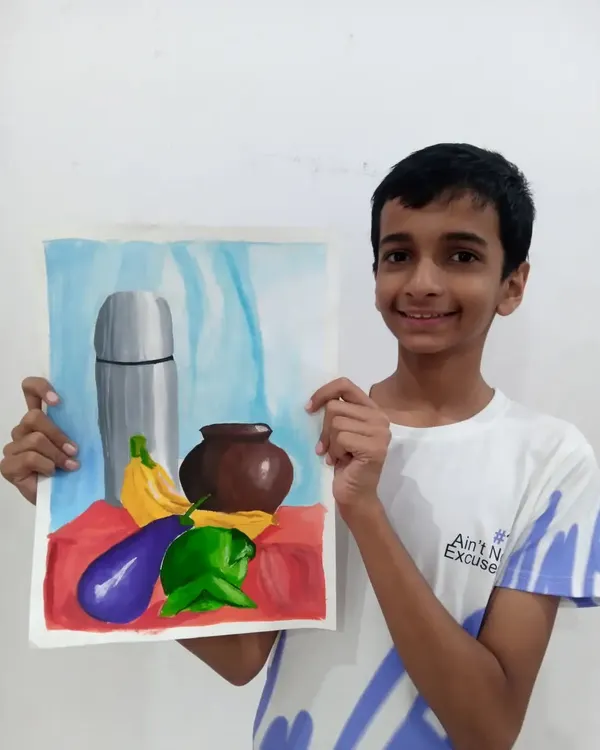Ishan, a 9th grader, proudly displays his still life painting of a flask, pot, and vegetables. This watercolour piece is excellent practice for the object drawing section of the art exams.