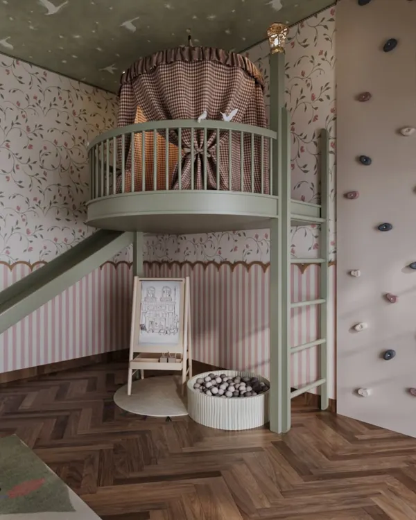 This view highlights the multi-level design of the playroom, featuring a climbing wall for adventurous spirits and a mezzanine fort for quiet moments. The combination of a slide, ball pit, and activity easel creates a layered environment for diverse play.