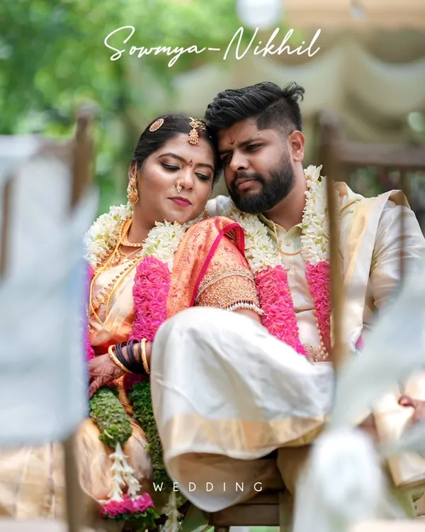 A tender moment between the bride and groom during their South Indian wedding ceremony. The soft focus and natural setting add to the romance of the shot.