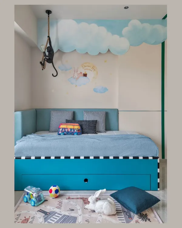 It's all about the small details in a kids' room. This space features a whimsical cloud mural, a fun monkey-shaped lamp, and a cozy daybed with plenty of hidden storage for toys.