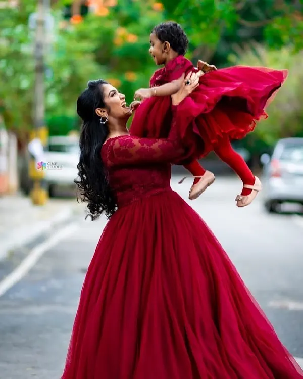 A heartwarming mother-daughter portrait. I styled them in matching deep red gowns, creating a beautiful visual connection that celebrates their bond.