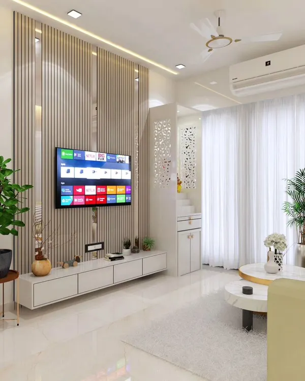 This living room design shows how I integrate modern aesthetics with Vastu principles. The space feels bright and positive, featuring a custom TV unit with vertical slats and an attached mandir, ensuring the sacred space is respected without compromising the room's contemporary style.