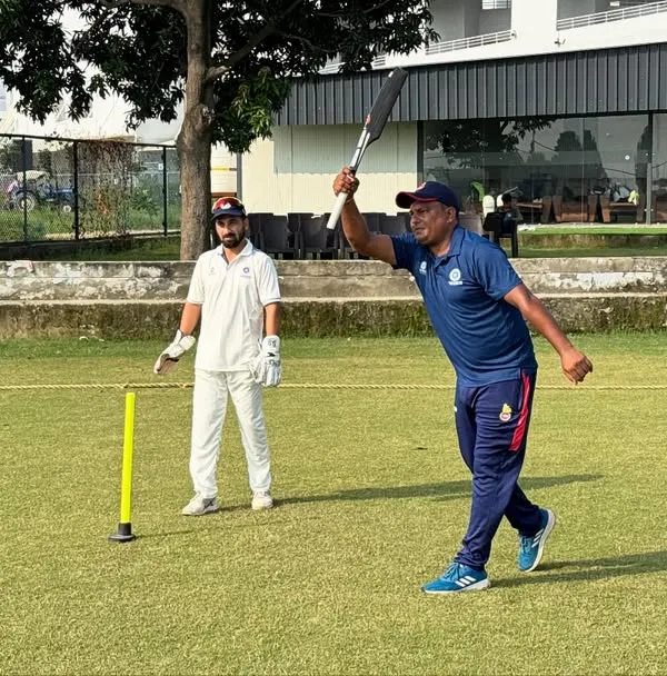 A coach demonstrates the correct form for a powerful shot. We believe in showing, not just telling, ensuring every player understands the fine details of technique in our group cricket coaching sessions.