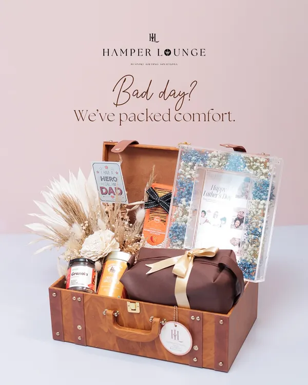 Dads have different moods, and my hampers match them. This vintage-style suitcase hamper is packed for comfort on a bad day, with snacks, brews, and a personalized photo frame for Father's Day.