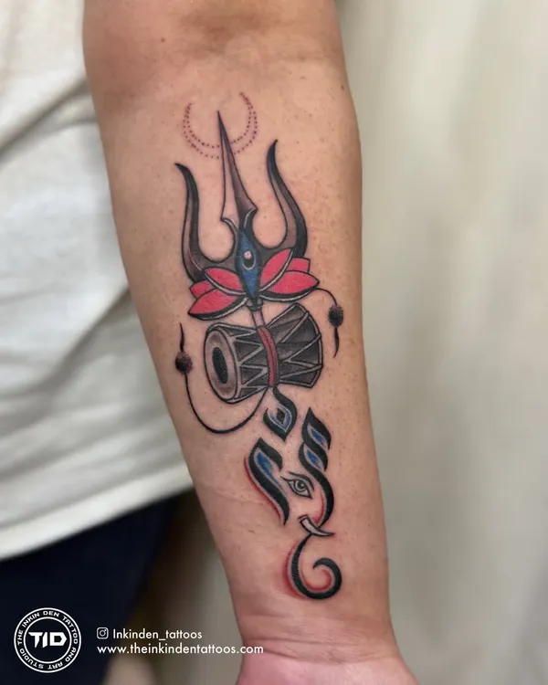 A custom design blending Lord Shiva's Trishul and Damru with a stylized Ganesha. The use of color highlights the lotus and adds a modern touch to these ancient symbols of power and new beginnings.