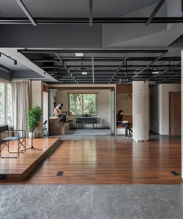 This wide view of the 'Chasing Tales' incubator captures the essence of our design: an open, fluid space with clearly defined functional zones. The elevated stage area provides a focal point, while breakout spaces and reading nooks are integrated along the periphery for quieter activities.