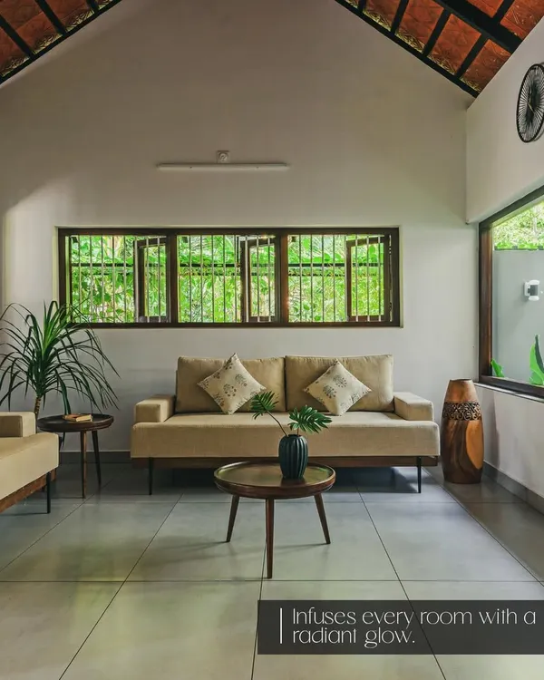 A tranquil living space where my custom sofas are complemented by carefully chosen accents, including a mid-century modern coffee table, indoor plants, and a beautifully carved wooden vase that adds a touch of traditional art.