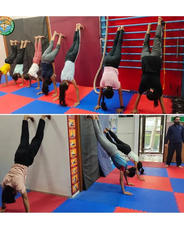 Handstand drills are a core part of our training to build shoulder strength and balance. Students practice against the wall and with partners to perfect their form.
