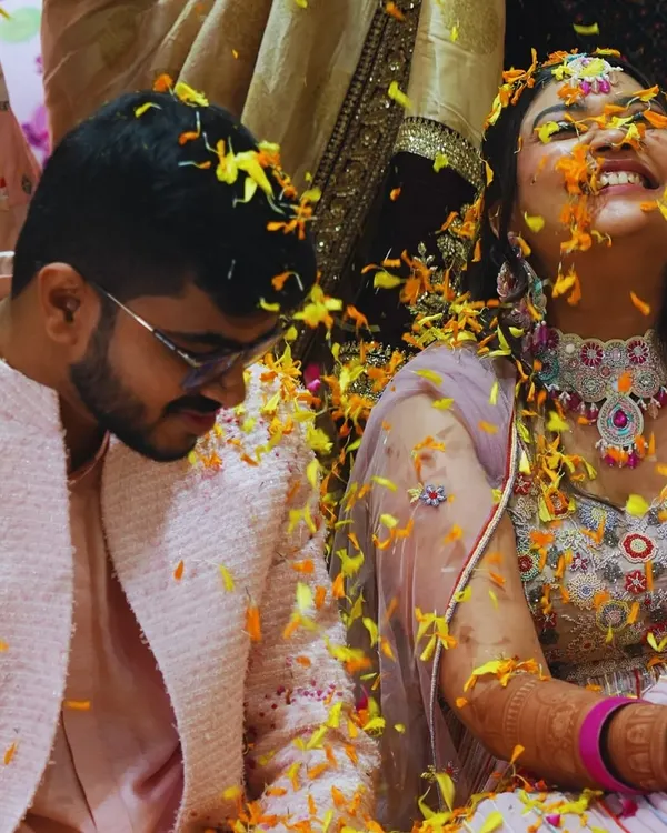 A moment of pure, unscripted joy during a 'Phoolon ki Haldi'. We believe the best memories are made when you're surrounded by love, laughter, and a shower of flower petals.