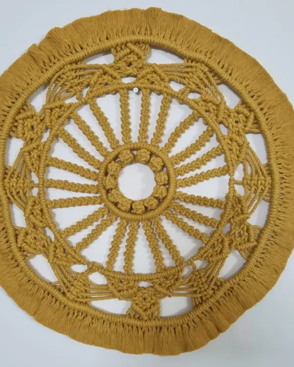 This intricate macrame mandala is a true labor of love, designed to be a stunning centerpiece for any wall. Each knot is carefully tied to create a symmetrical, textured piece of fiber art that brings a sense of peace and bohemian elegance to your space.