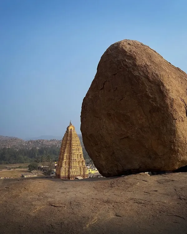 A classic Hampi view. Using the massive granite boulder to frame the historic temple shows the interplay between nature and architecture in this UNESCO World Heritage site.