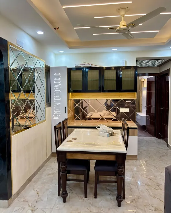 A dining area featuring a custom crockery unit with glossy black cabinets and a backsplash made of diamond-patterned mirrors.