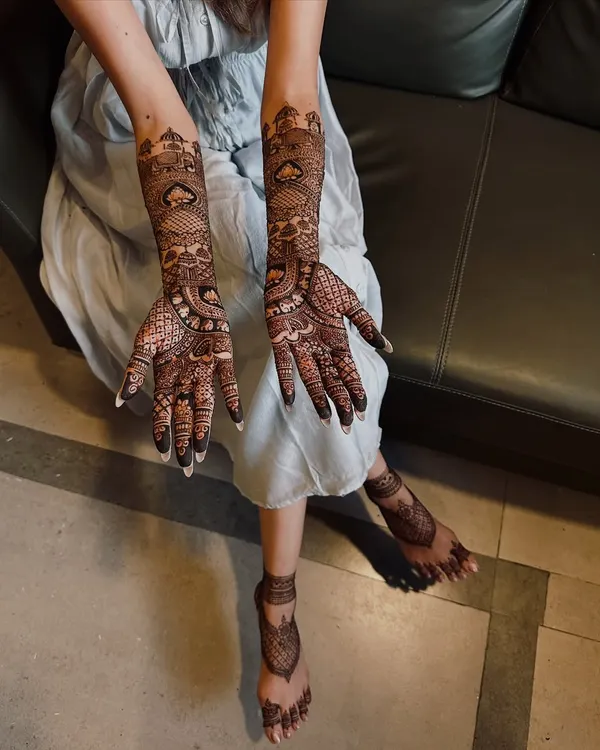 A complete view of a full bridal mehndi set. The design features matching motifs on the hands and feet, creating a harmonious and traditional look for the bride.