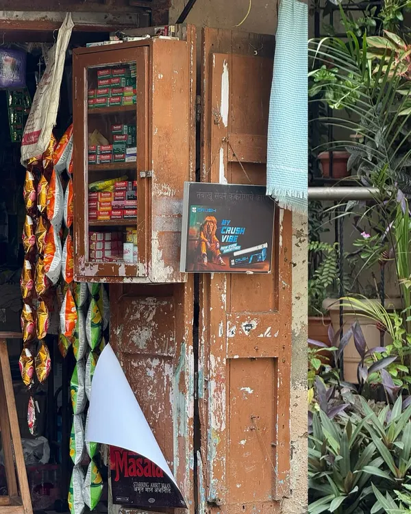 A fading corner that's seasoned by stories. This shot of a small kirana store, with its weathered wooden cabinet and hanging snacks, captures the timeless charm of neighborhood life.