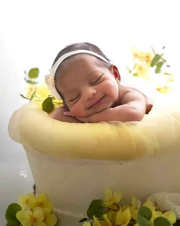 That first, sweet, sleepy smile is a moment of pure magic. I focus on capturing these fleeting expressions in a soft, dreamy setting, creating a timeless portrait of your baby's joy.