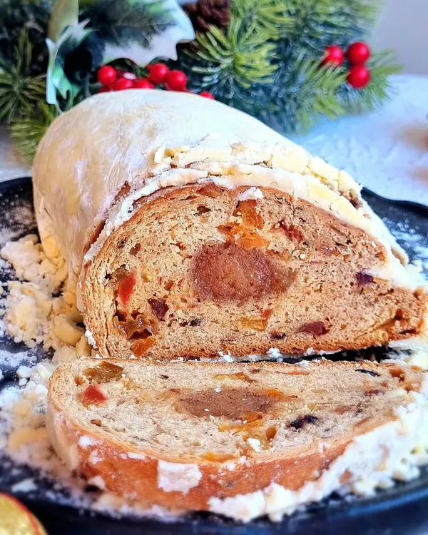 A classic German Christmas Stollen, a bread-like fruitcake filled with dried fruit and a center of marzipan. I teach the traditional recipe for this festive holiday bake.