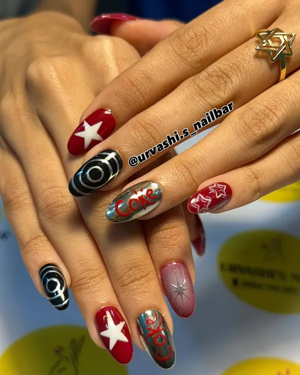 A retro and fun set inspired by Coca-Cola. I combined the iconic logo on a chrome nail with bold red, stars, and graphic black and white swirls for a pop-art vibe.
