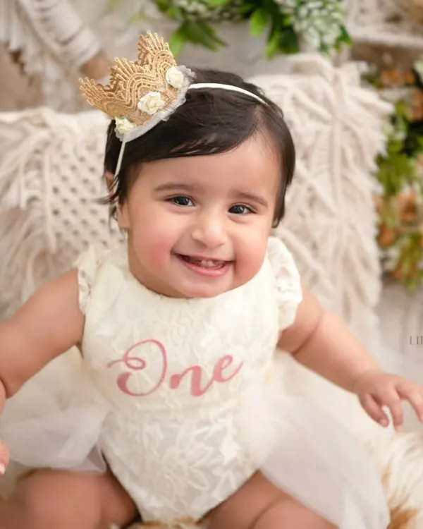 This is the kind of pure, radiant joy I aim to capture. This little one's first birthday portrait, set against a soft, rustic backdrop, is a perfect example of how I turn a milestone into a masterpiece.