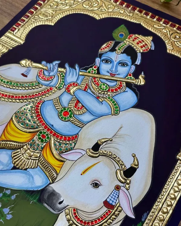 Krishna Mana Mohana, Chitha Chora Radha Jeevana. This beautiful finished painting captures Krishna playing his flute, resting beside his beloved cow, under an ornate golden arch.