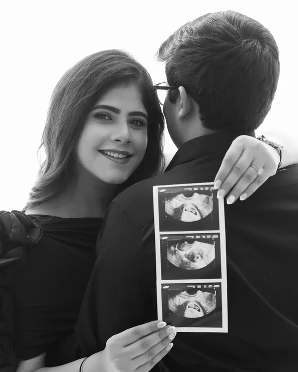 A beautiful way to announce your journey. This black and white shot focuses on the joy in her eyes and the precious sonogram, telling the story of what's to come.