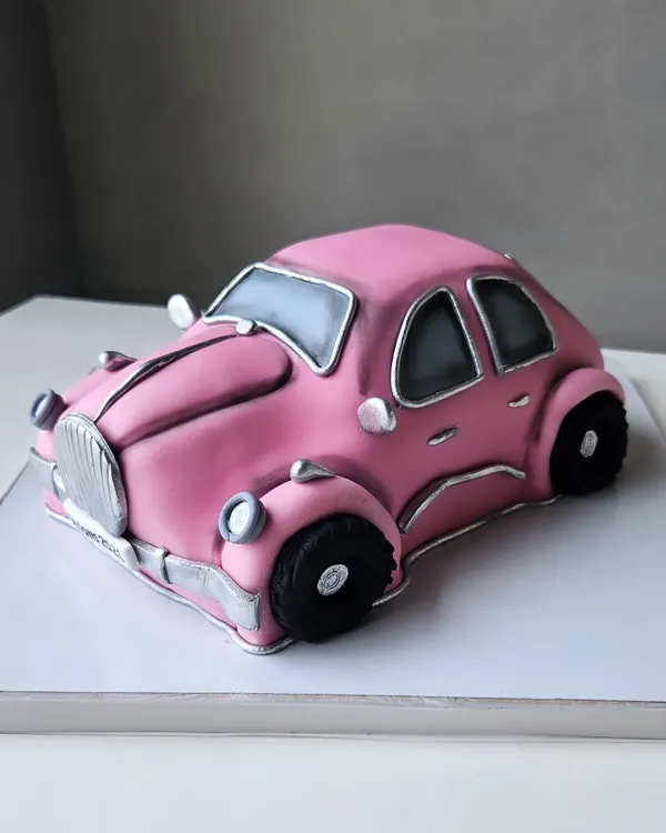 A vintage pink car, sculpted entirely from cake. This was a collaborative project where I got to bring this Barbie-est car to life.